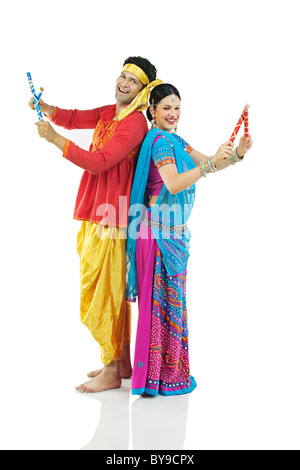 Gujarati couple performing dandiya dance Stock Photo - Alamy