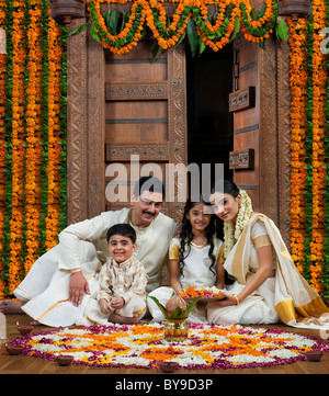South Indian family with flower rangoli Stock Photo