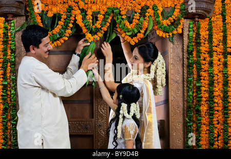 South Indian family decorating during Onam festival Stock Photo