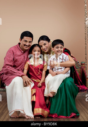 Portrait of a South Indian family sitting on a jhula Stock Photo