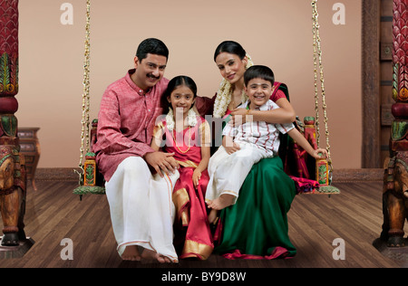 Portrait of a South Indian family sitting on a jhula Stock Photo