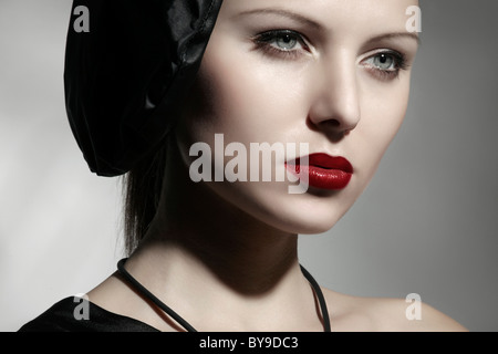 Young woman wearing an elegant black dress and hat, portrait Stock Photo