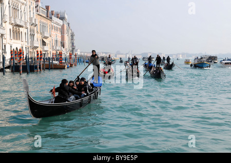Gondolas with passengers from a tour group on a gondola ride, Canale Grande, Grand Canal, Venice, Veneto, Italy, Europe Stock Photo