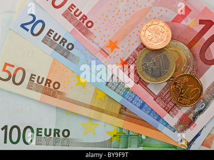 Fan of various euro banknotes and coins Stock Photo