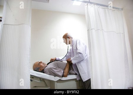 Doctor checking a patient's heartbeat Stock Photo
