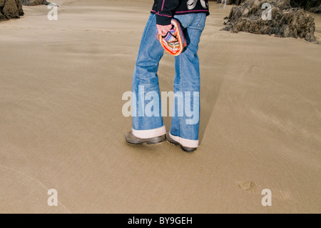 Womans legs on a beach in Pembrokeshire Stock Photo