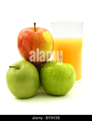 A stack of apples and a glass of orange juice on a white background Stock Photo