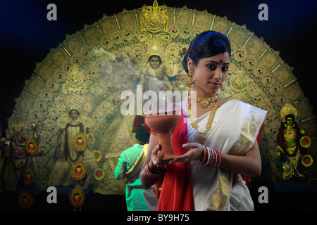 Bengali woman holding a dhunuchi Stock Photo