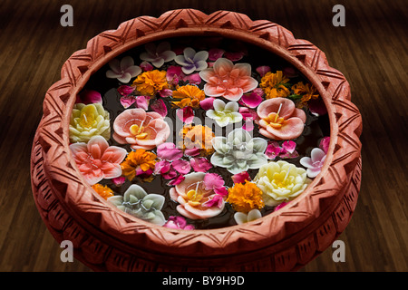 Flower diyas floating in a pot with water Stock Photo