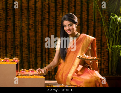 Woman arranging diyas Stock Photo