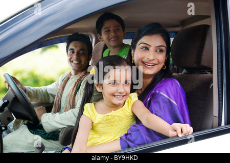 Family sitting inside a car Stock Photo