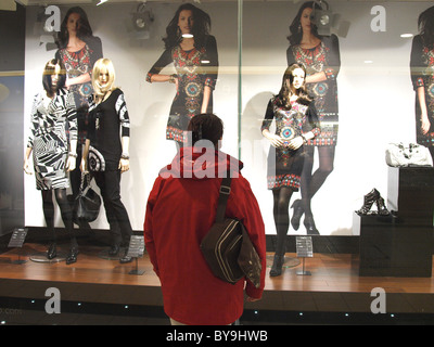 Woman looking at shop window display, UK Stock Photo