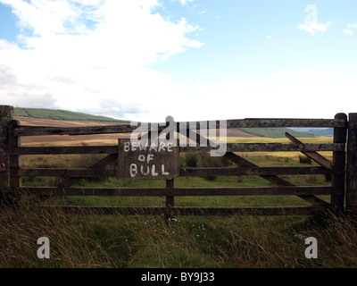 A sign on a fence that reads: Beware of Bull, honest is the best policy. Stock Photo