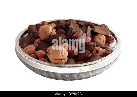 A Bowl of mixed nuts in shells on white background Stock Photo