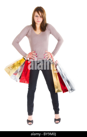 angry young woman standing with shopping bags over white background Stock Photo