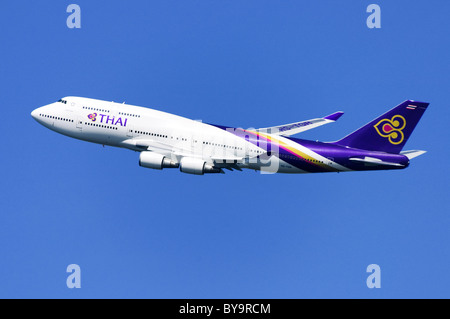 Boeing 747 operated by Thai Airways climbing out after take off from London Heathrow Airport Stock Photo