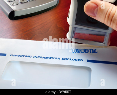 Letter with confidential stamp on the table Stock Photo