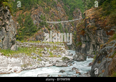 suspension bridge crossing over the Dudh Kosi River in the Everest region of Nepal Stock Photo