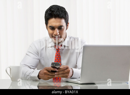 Businessman sending a text message Stock Photo