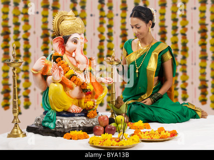 Woman performing a pooja Stock Photo