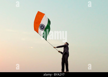 Businessman holding the Indian flag Stock Photo