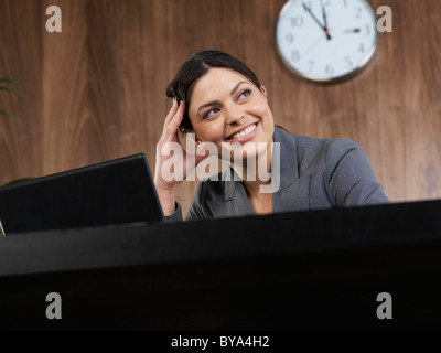 Business woman working at her desk Stock Photo