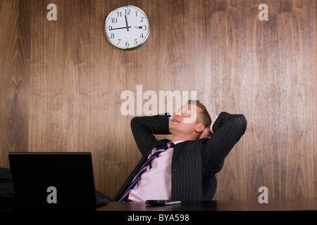 Business man at desk relaxing Stock Photo