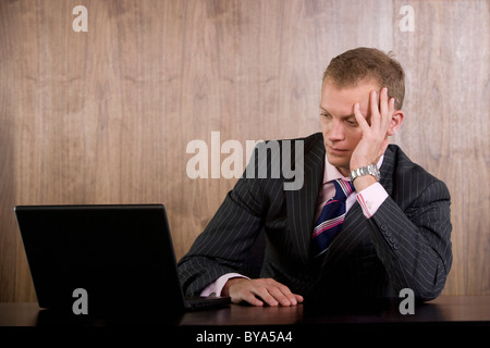 Unhappy business man looking at computer Stock Photo