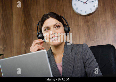 Business woman on telephone headset Stock Photo