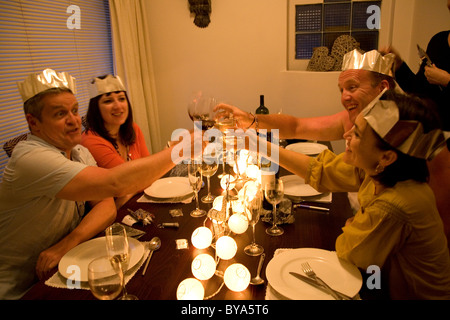 Group toasting one another at Xmas Table Stock Photo