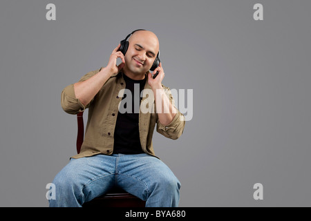 Bald man listening to music Stock Photo