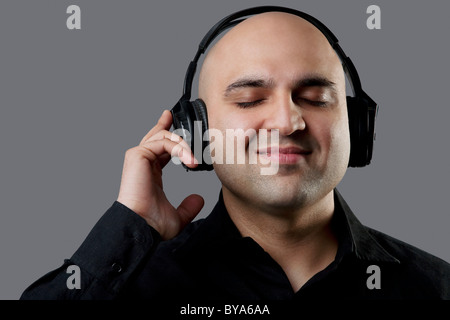 Bald man listening to music Stock Photo