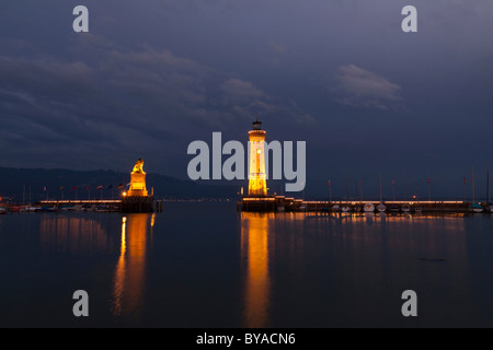 Lighthouse and the Bavarian lion, symbol of the city, at the harbour entrance of Lindau on Lake Constance, Bavaria Stock Photo