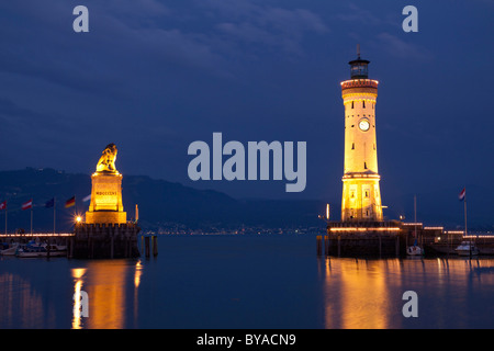 Lighthouse and the Bavarian lion, symbol of the city, at the harbour entrance of Lindau on Lake Constance, Bavaria Stock Photo