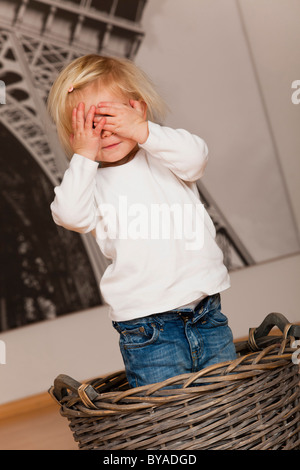 Girls, 1.5 years, playing hide and seek Stock Photo