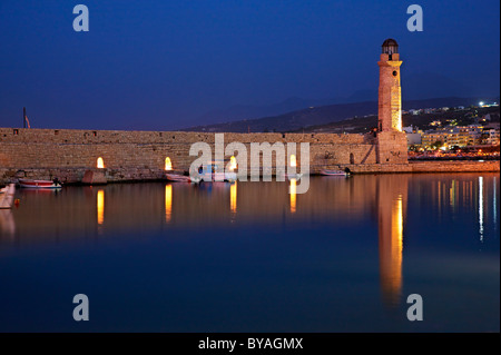 The lighthouse of the old Venetian harbor of Rethymno town around the 'blue' hour. Crete island, Greece. Stock Photo