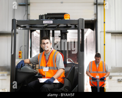 Workers with forklift truck