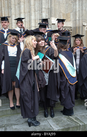 graduates from York St John University celebrating outside York Minster, York, England, UK Stock Photo