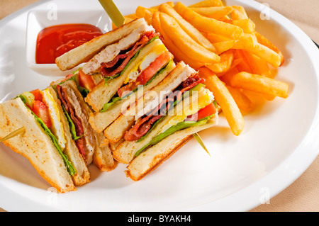 fresh triple decker club sandwich with french fries on side Stock Photo