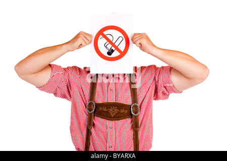 Bavarian man in lederhose holds no-smoking-rule sign in front of face. Isolated on white background. Stock Photo