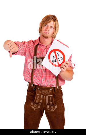Smiling Bavarian man in lederhose agrees to non-smoking-rule. Isolated on white background. Stock Photo