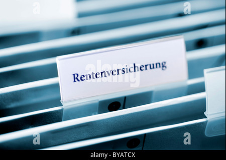 Rider on a hanging folder labeled Rentenversicherung or pension Stock Photo