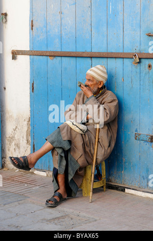 Old man with walking stick is resting, Essaouira, Morocco, Africa Stock Photo