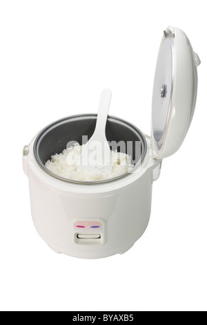 Cooked rice in electric cooker with plastic spoon on white background Stock Photo