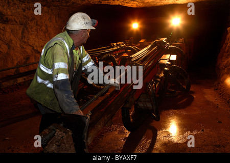 Miner at work in a modern mine Stock Photo