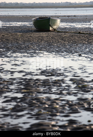 Boat at low tide in estuary southern ireland eire Stock Photo