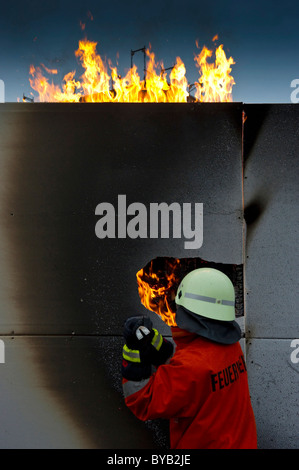 Firefighter extinguishing a fire Stock Photo