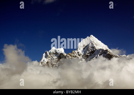 Clouds in front of Mt. Kangtega and Mt. Thamserku, Khumbu, Sagarmatha National Park, Nepal, Asia Stock Photo