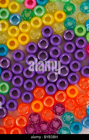 beads plastic many pieces colors colorful background scrapbook scrapbooking sparkle happy happiness fun tiny macro close up purp Stock Photo