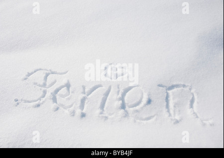 The word Ferien or holiday written in snow, winter, Landshut, Lower Bavaria, Bavaria, Germany, Europe Stock Photo